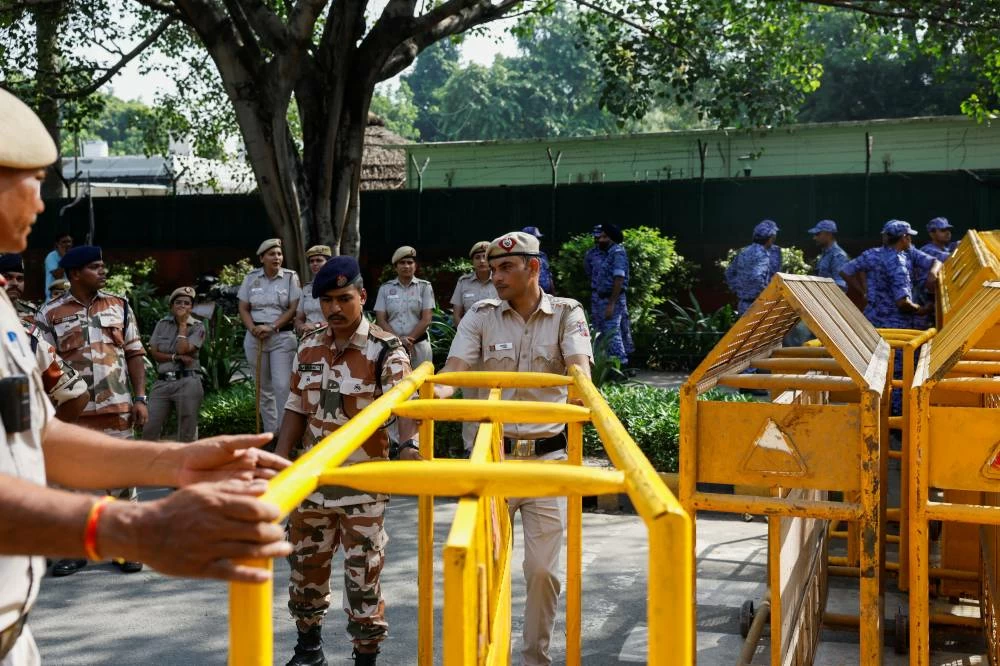 Security personnel drag a barricade at a protest site ahead of a protest demanding the resignation of India's Chief Election Commissioner Gyanesh Kumar, in New Delhi, India, October 2, 2026. REUTERS/Adnan Abidi